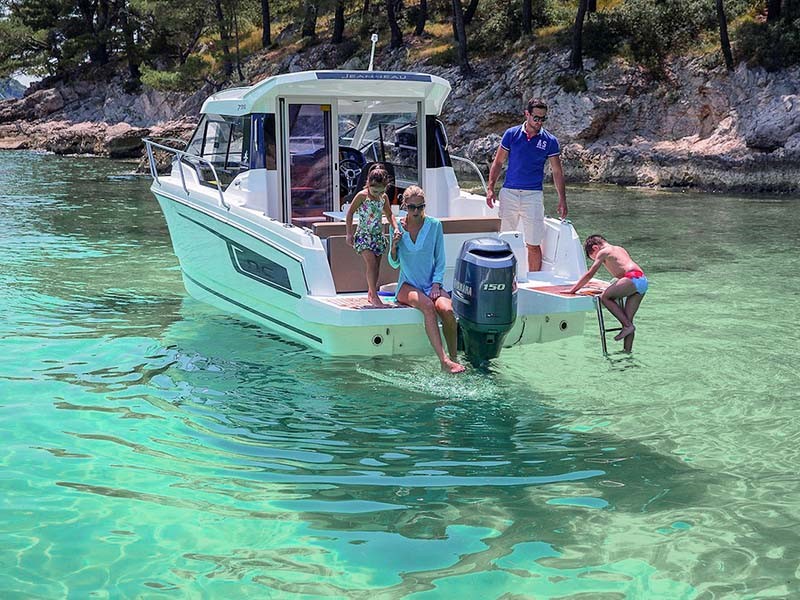 Photo of the Jeanneau NC 795 in a bay with clear water