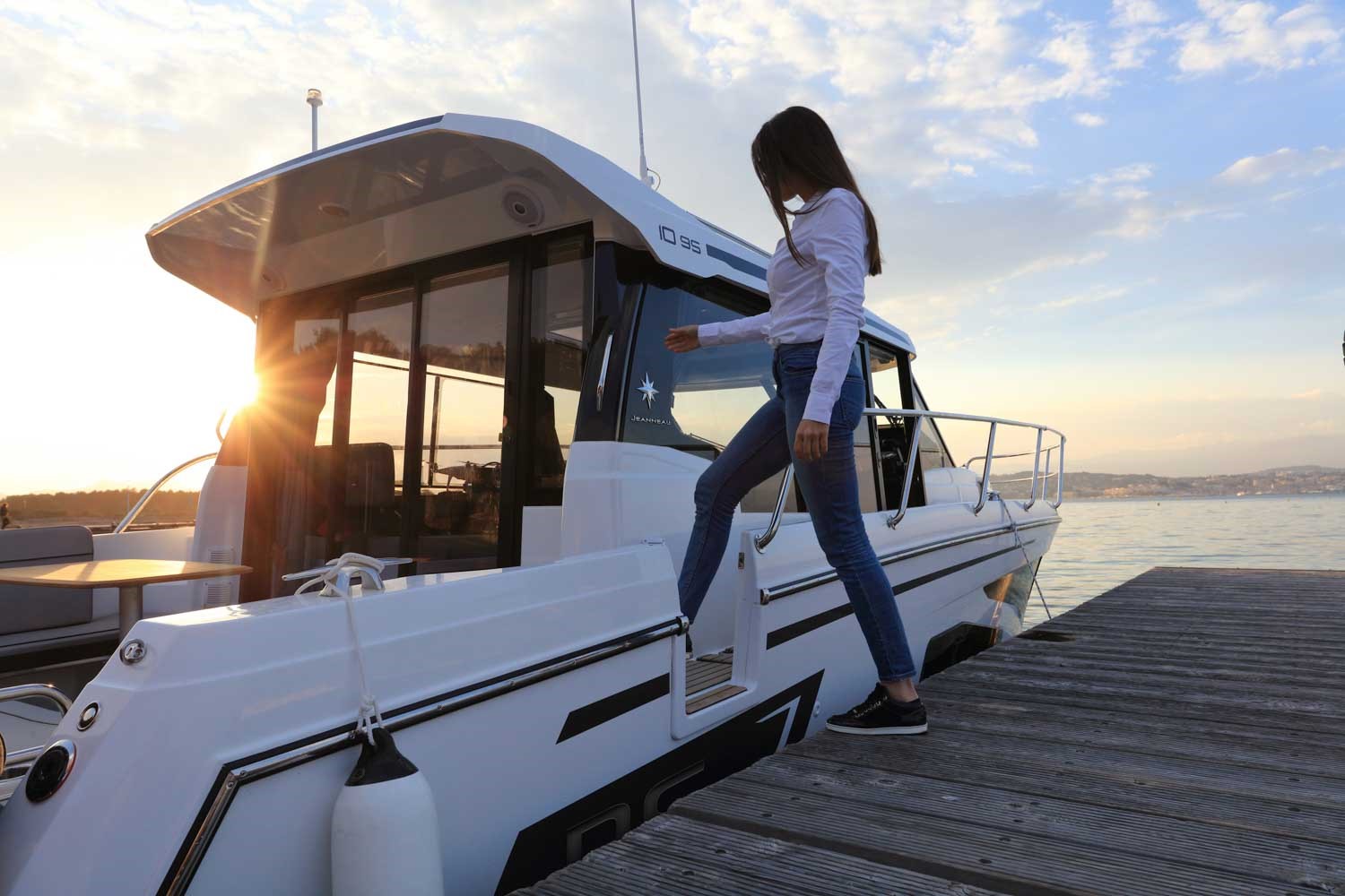 Woman stepping onto Jeanneau NC 1095