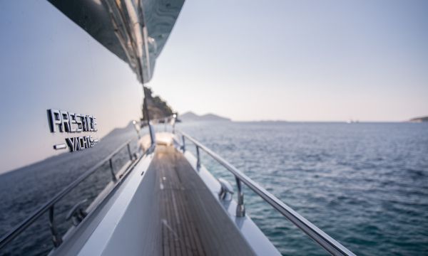 Looking down the side deck of a Prestige Yacht on the water