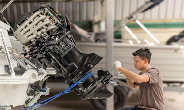 Marine mechanic working on an outboard engine 